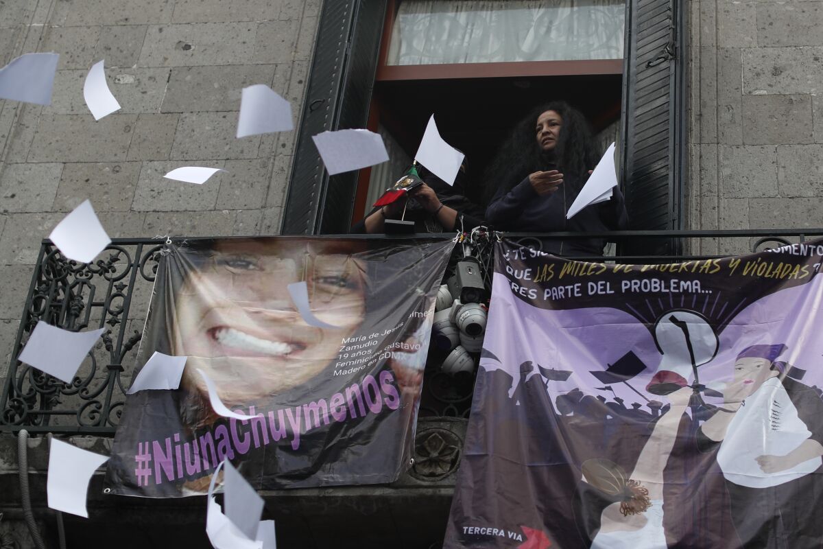 Gender violence activist Yesenia Zamudio throws papers out a window at Mexico's National Human Rights Commission office.