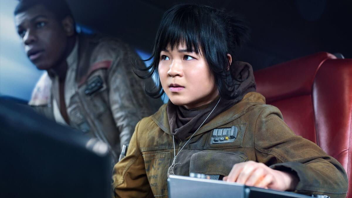 (L-R) - John Boyega as 'Finn' and Kelly Marie Tran as 'Rose' in a scene from the movie "Star Wars: The Last Jedi." Credit: Jonathan Olley / Lucasfilm Ltd.