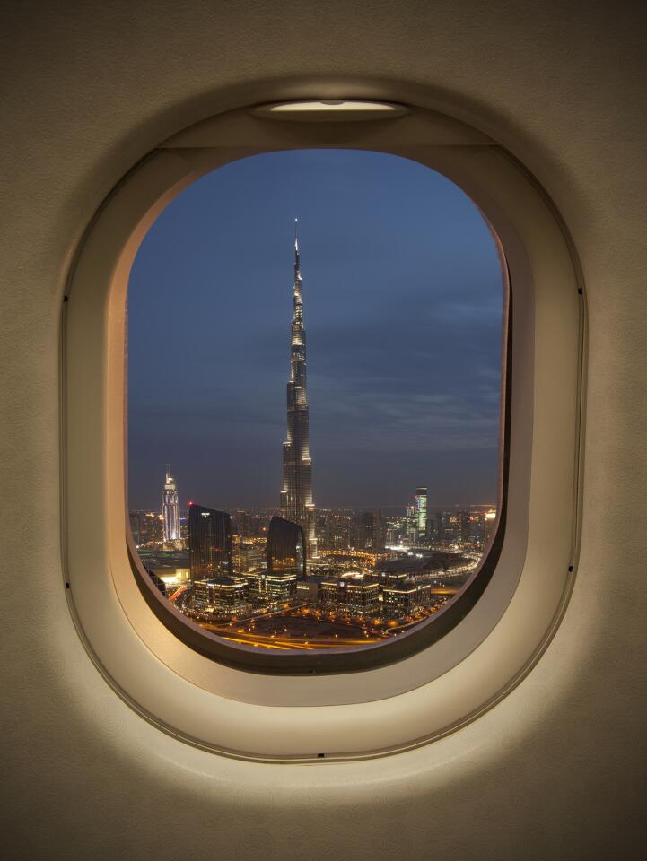 Dubai's soaring Burj Khalifa skyscraper, seen from an airplane window.