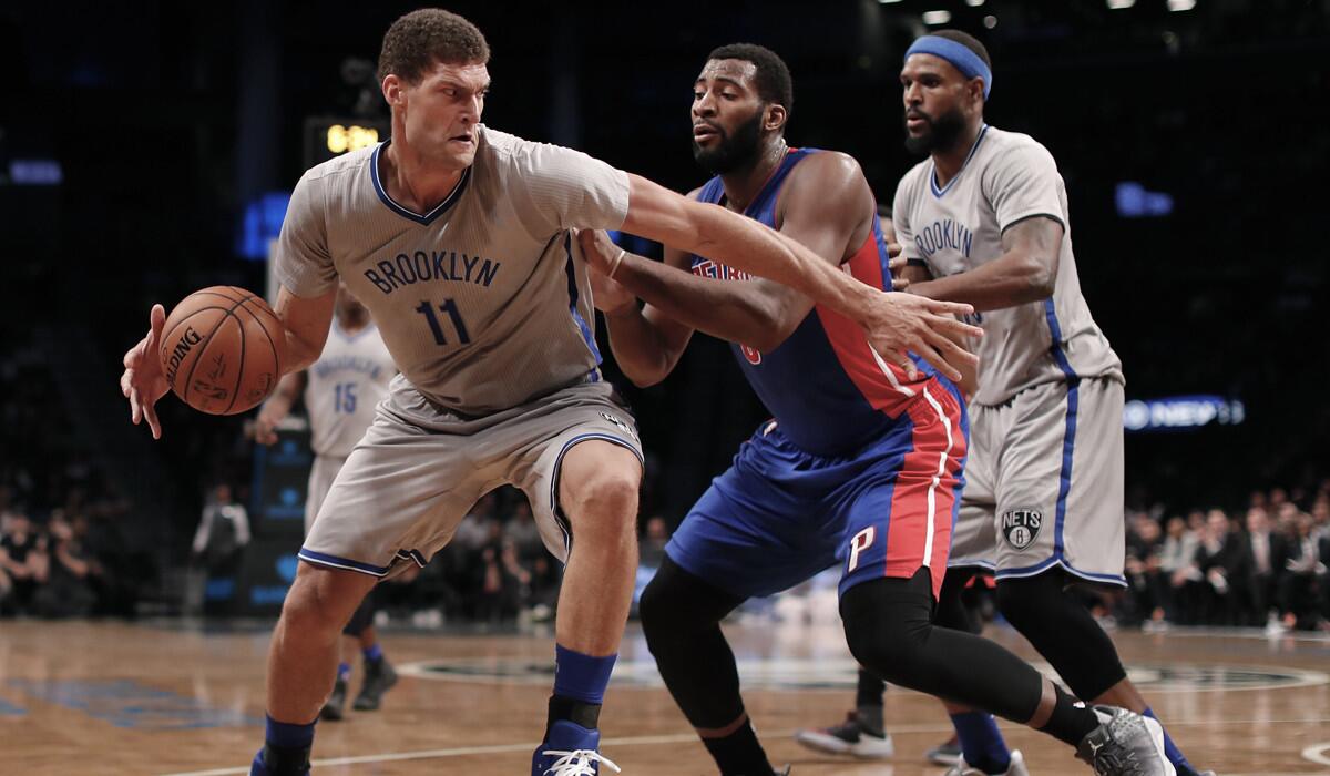 Brooklyn Nets center Brook Lopez (11) turns to drive against Detroit Pistons center Andre Drummond during the third quarter Wednesday.