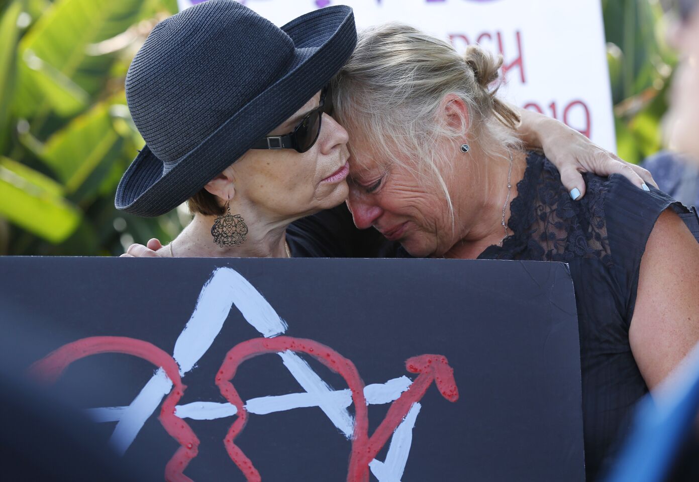 Leslie Gollub, left, and Gretchen Gordon comfort each other as they support the Jewish community at a rally not far from the Chabad of Poway, where a deadly shooting took place the day before on April 28, 2019 in Poway, California.