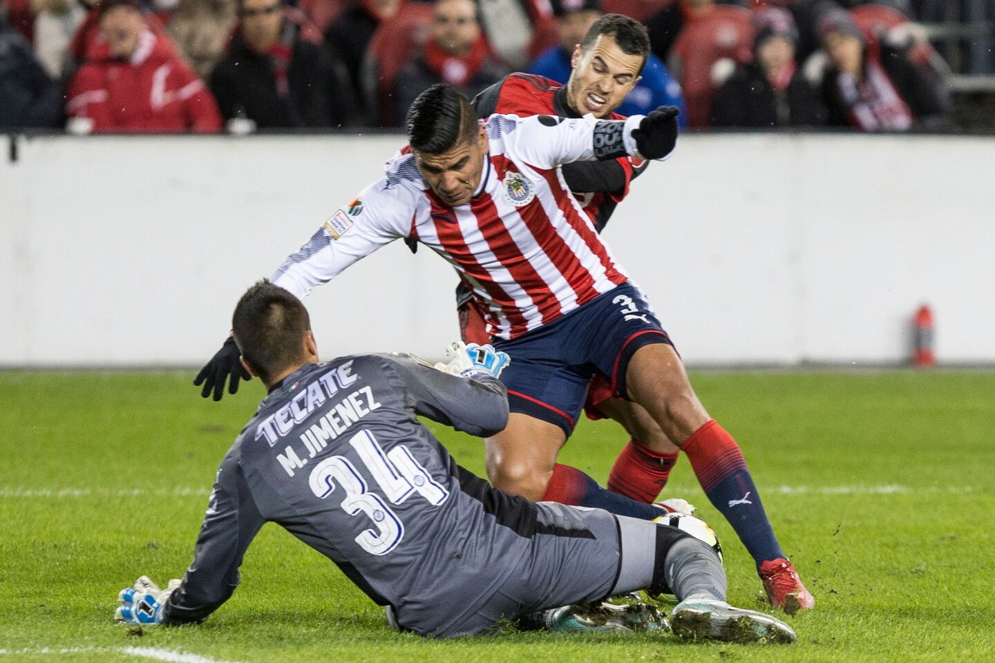 Guadalajara's Carlos Salcido (3) and goalkeeper Miguel Jimenez combine to thwart Toronto FC's Sebastian Giovinco during the first half in the first leg of the CONCACAF Champions League soccer final, Tuesday, April 17, 2018, in Toronto. (Chris Young/The Canadian Press via AP)