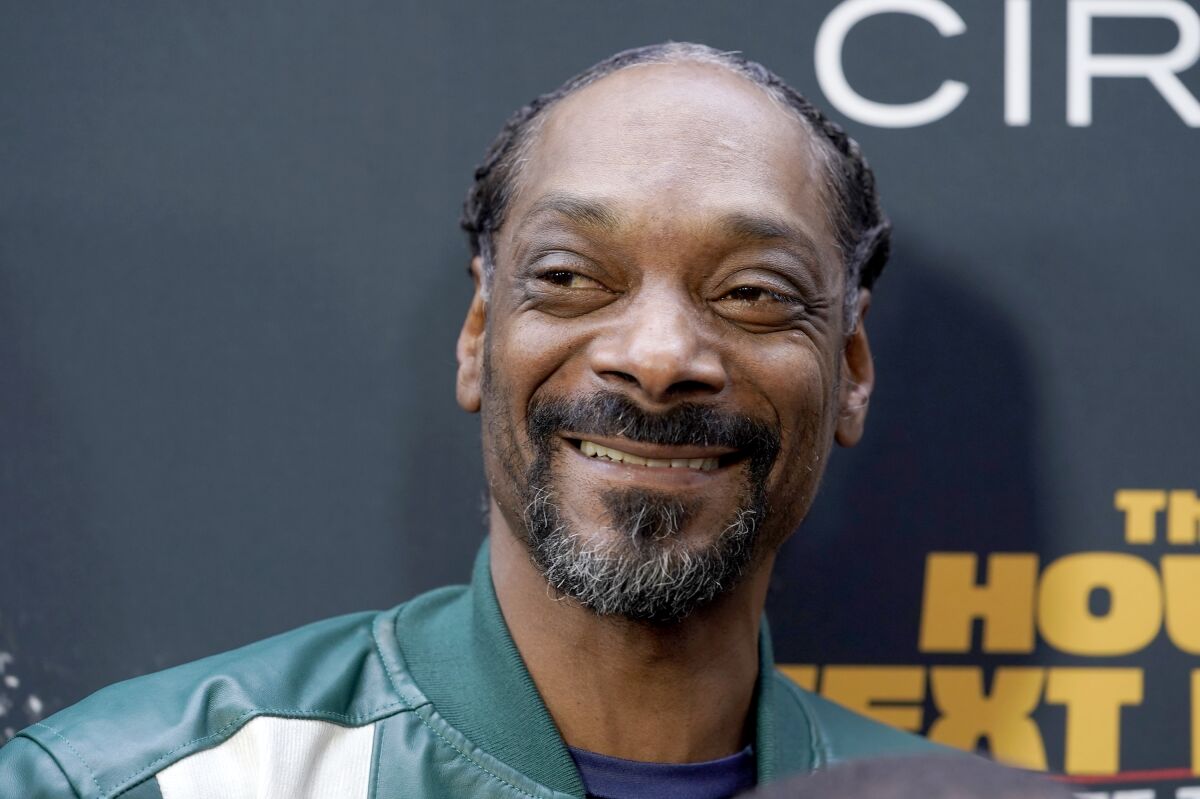 FILE - Snoop Dogg poses at the premiere of "The House Next Door: Meet The Blacks 2," on June 7, 2021, in Los Angeles. The rapper-mogul acquired Death Row Records, the label that launched his career, from MNRK Music Group, which is controlled by private equity fund managed by Blackstone, the investment firm announced Wednesday, Feb. 9, 2022. (AP Photo/Chris Pizzello, File)