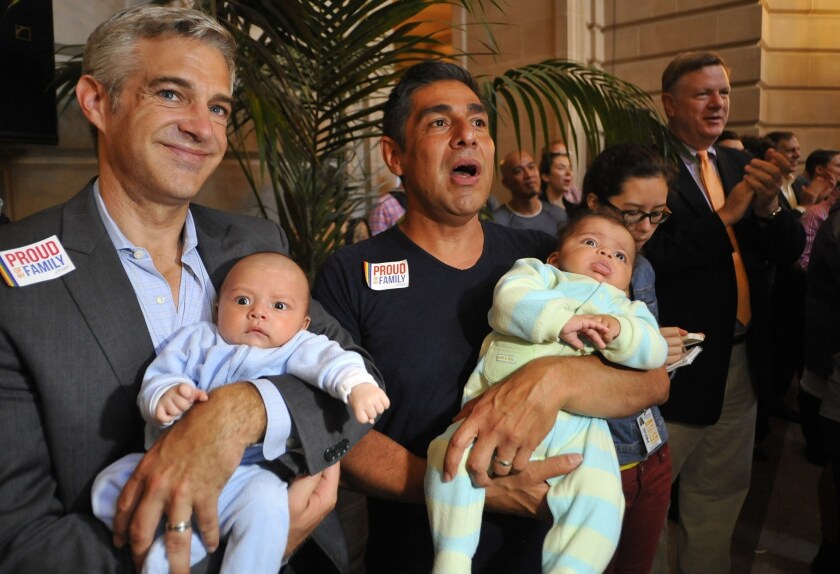 Chris Roe, left, and Roby Chavez celebrate the Supreme Court's decision to strike down the Defense of Marriage Act while holding their soon-to-be adopted children in San Francisco.