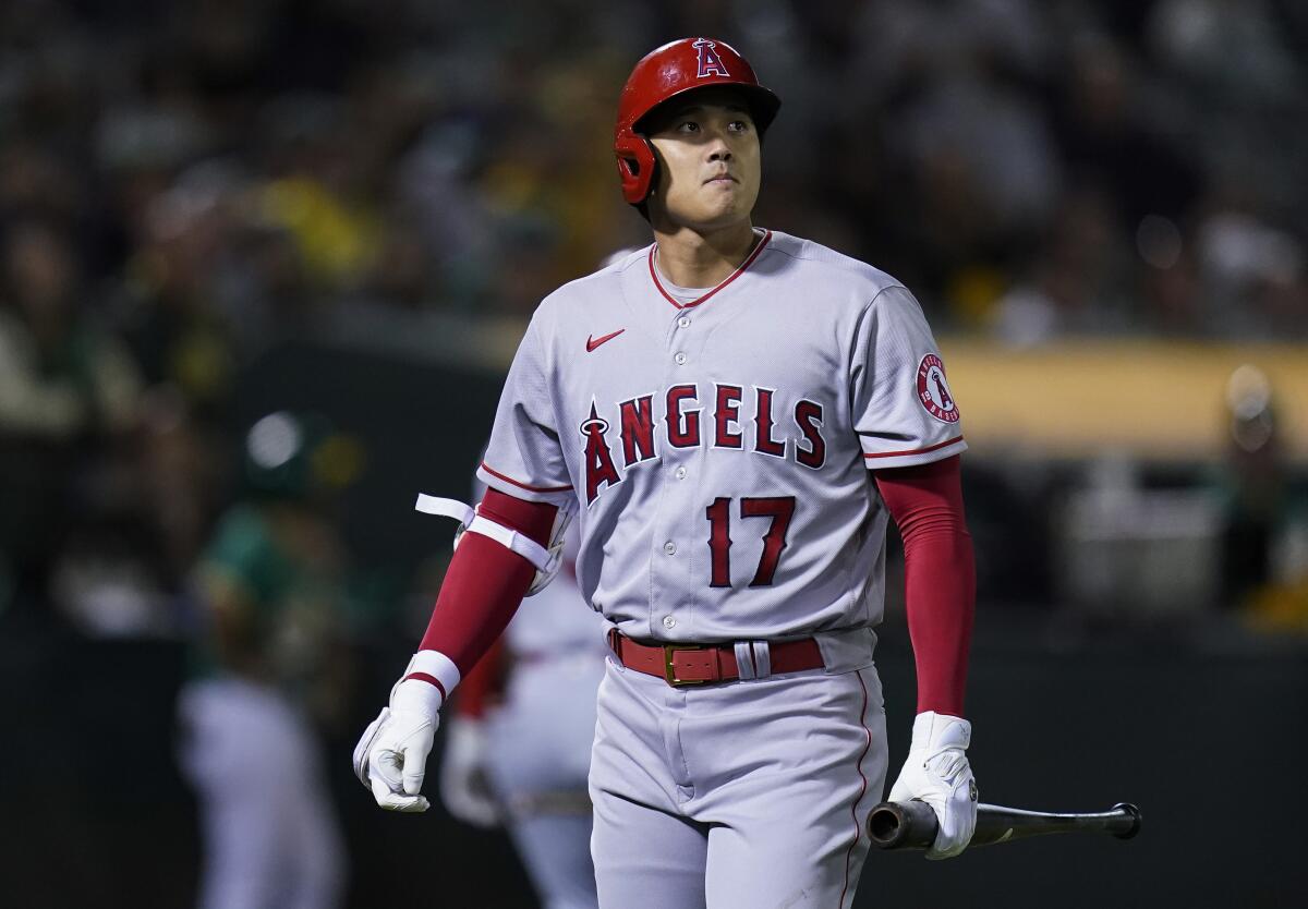 Angels' Shohei Ohtani walks to the dugout after striking out.