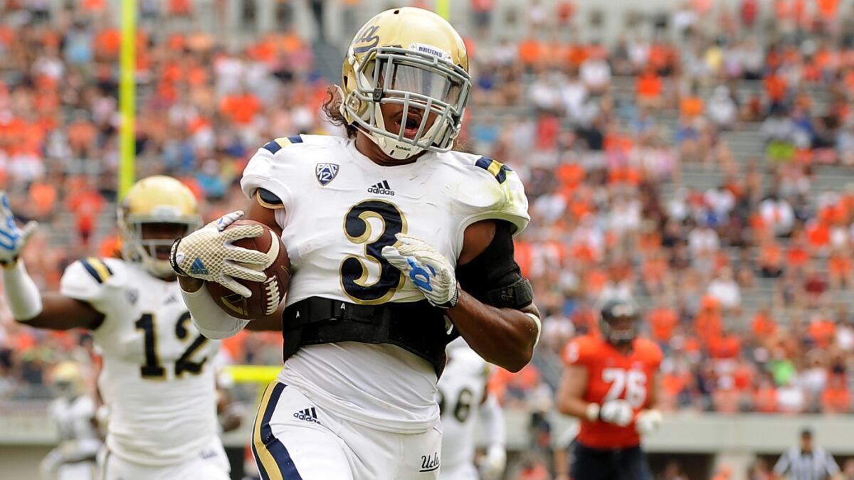 UCLA safety Randall Goforth scores on a fumble return during a win over Virginia.