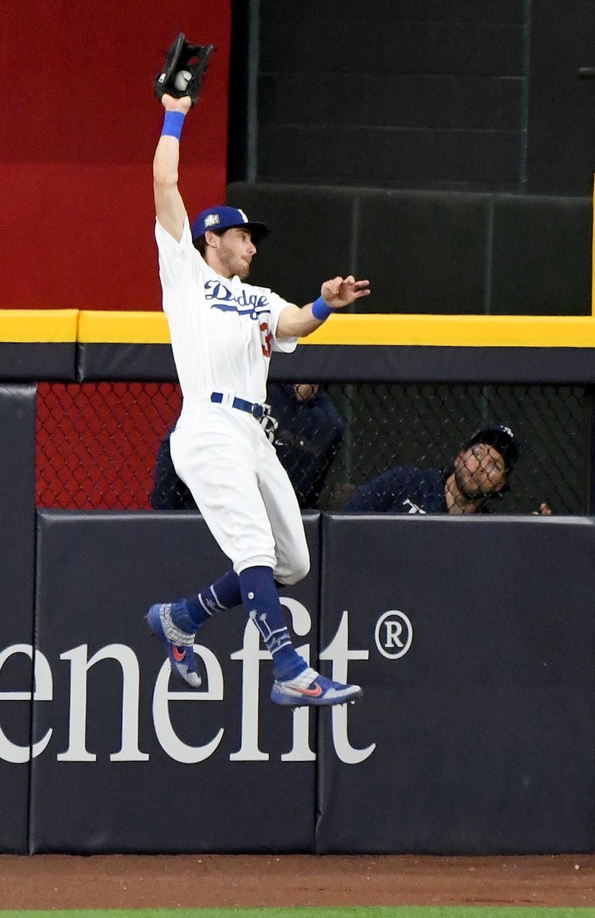 Dodgers center fielder Cody Bellinger makes a catch at the wall in front of the Rays bullpen in the 9th inning.