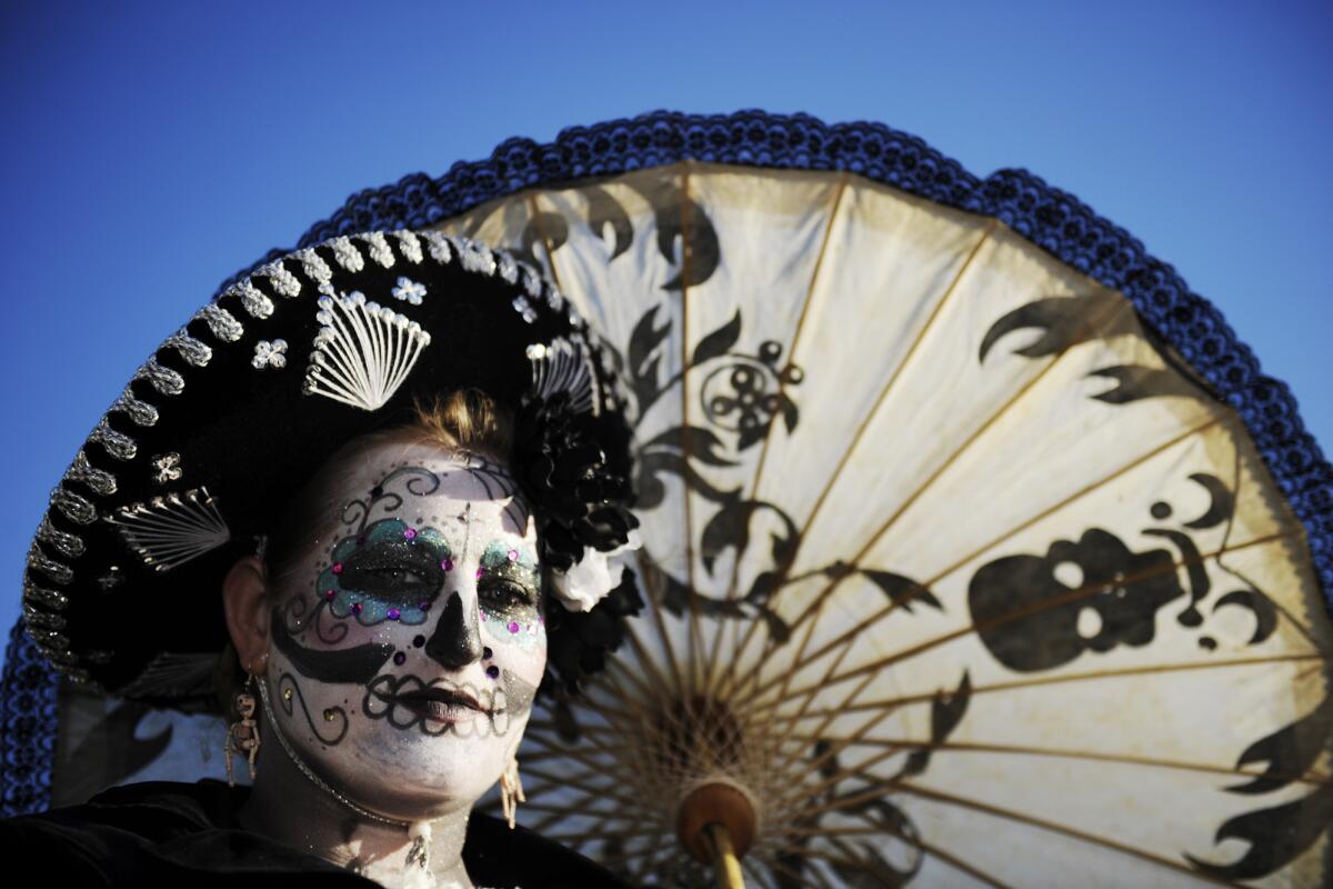 A woman with face paint at Hollywood Forever Cemetery for Dia de Los Muertos