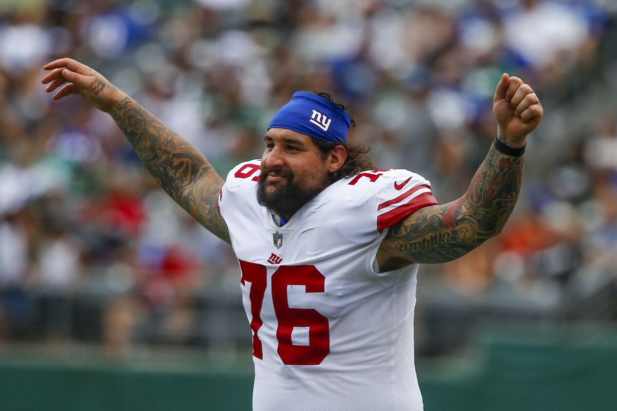 New York Giants guard Jon Feliciano (76) reacts on the sidelines in the second half of a preseason NFL football game against the New York Jets, Sunday, Aug. 28, 2022, in East Rutherford, N.J. (AP Photo/John Munson)