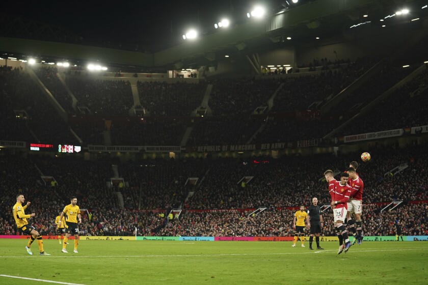 Wolverhampton Wanderers' Romain Saiss hits the post from a free kick during the English Premier League soccer match between Manchester United and Wolverhampton Wanderers at Old Trafford stadium in Manchester, England, Monday, Jan.3, 2022. (AP Photo/Dave Thompson)