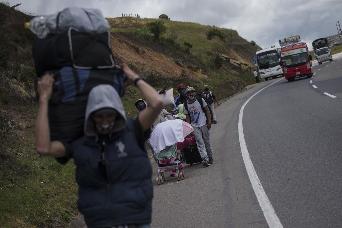 Venezuelan migrants pass through Tunja, Colombia, Tuesday, Oct. 6, 2020. 