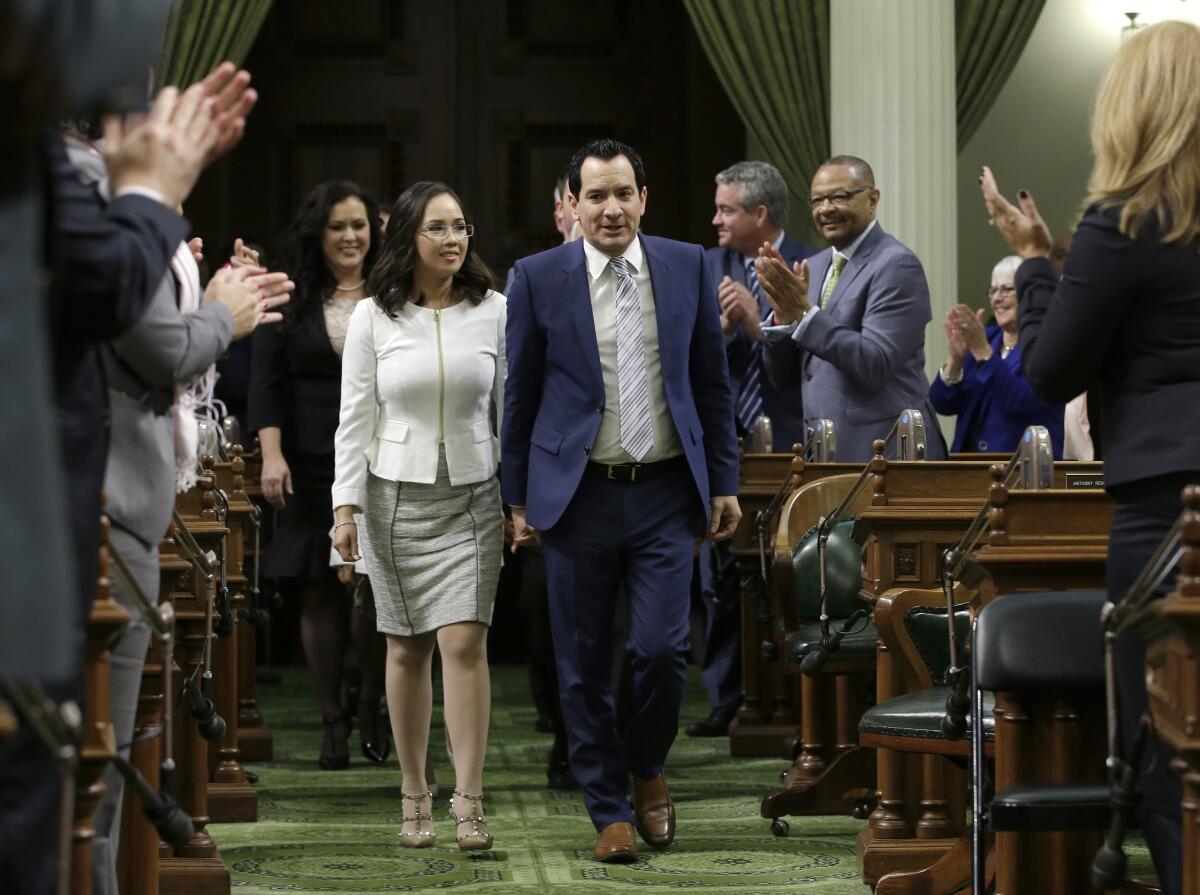 Anthony Rendon and Annie Lam walk down the center aisle of the Assembly. 
