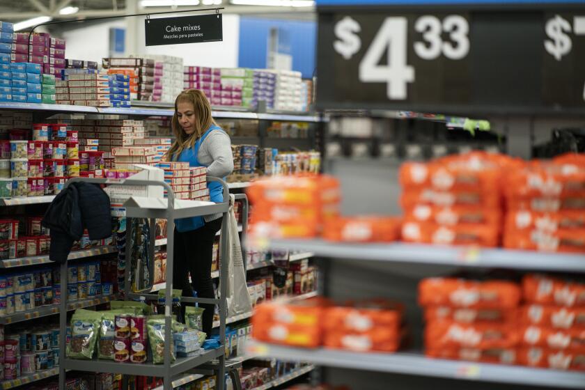 A worker organizes items at a Walmart Supercenter in North Bergen, N.J., on Thursday, Feb. 9, 2023. On Tuesday, the Labor Department reports on U.S. consumer prices for February. (AP Photo/Eduardo Munoz Alvarez)