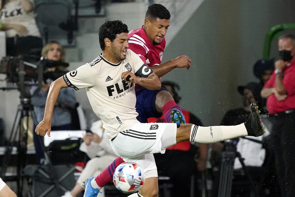 LAFC forward Carlos Vela stops a shot from Dallas FC midfielder Bryan Acosta.