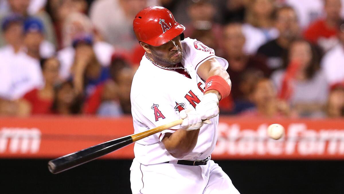 Angels first baseman Albert Pujols hits a run-scoring single during the fifth inning of the team's 5-2 win over the Toronto Blue Jays at Angel Stadium on Monday.