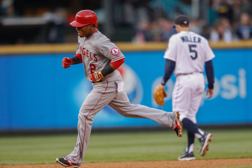 Erick Aybar rounds the bases after hitting a three-run home run in the fourth inning at Safeco Field in a 7-5 win over the Mariners in Seattle.