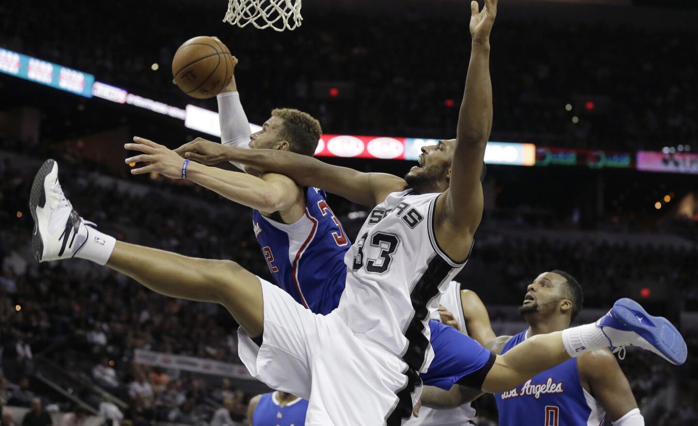 Clippers forward Blake Griffin pulls down a rebound against Spurs forward Boris Diaw in the second half of Game 4.