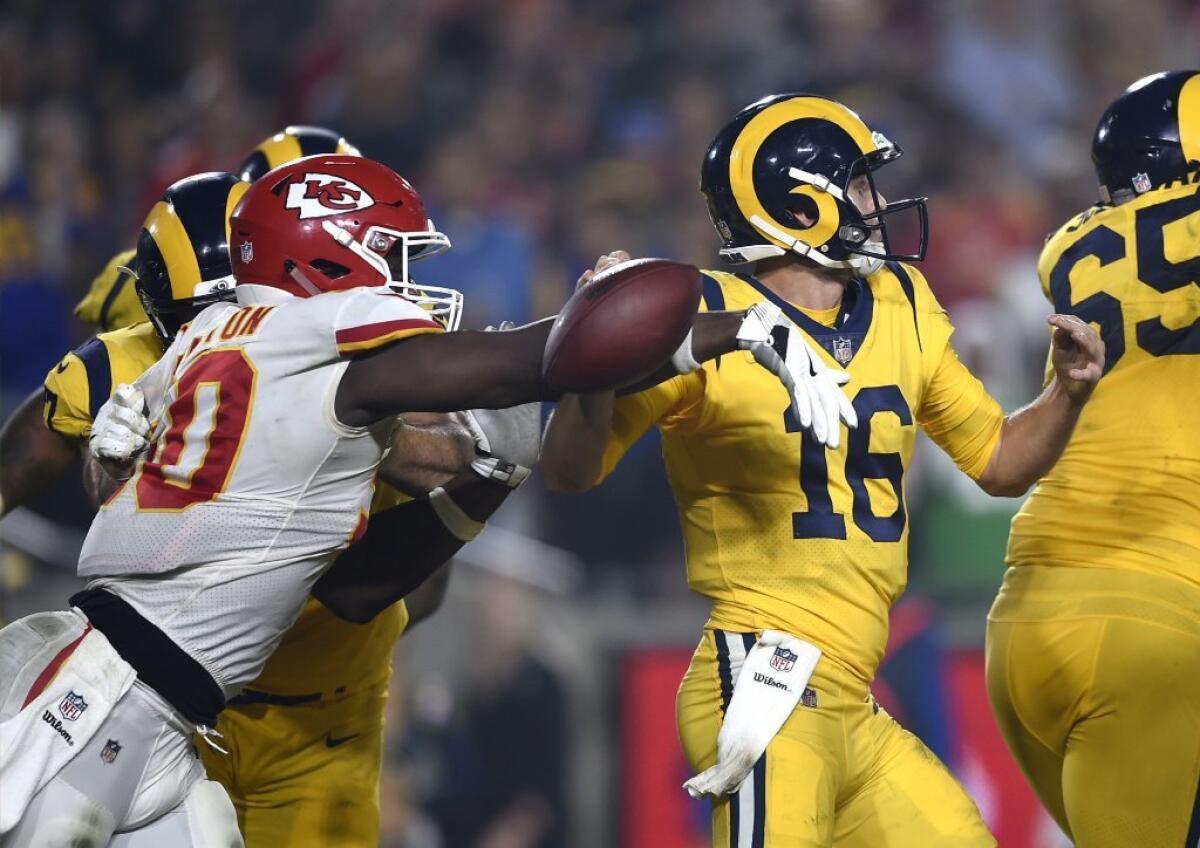 Chiefs outside linebacker Justin Houston, left, strips the ball away from Rams quarterback Jared Goff (16).