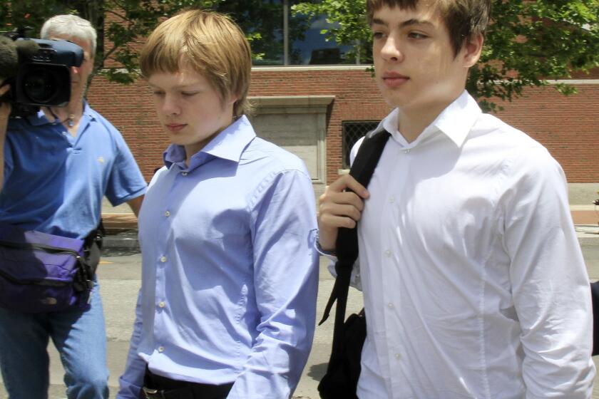 FILE - In this July 1, 2010, file photo, Alex Vavilov, right, and his older brother brother Tim leave a federal court after a bail hearing for their parents Donald Heathfield and Tracey Ann Foley, in Boston, Massachusetts. Canada's Supreme Court has ruled on Thursday, Dec. 19, 2019, that Alex Vavilov, the son of a Russian spy couple who lived clandestine lives in Canada and the United States, can keep his Canadian citizenship. (AP Photo/Elise Amendola, File)
