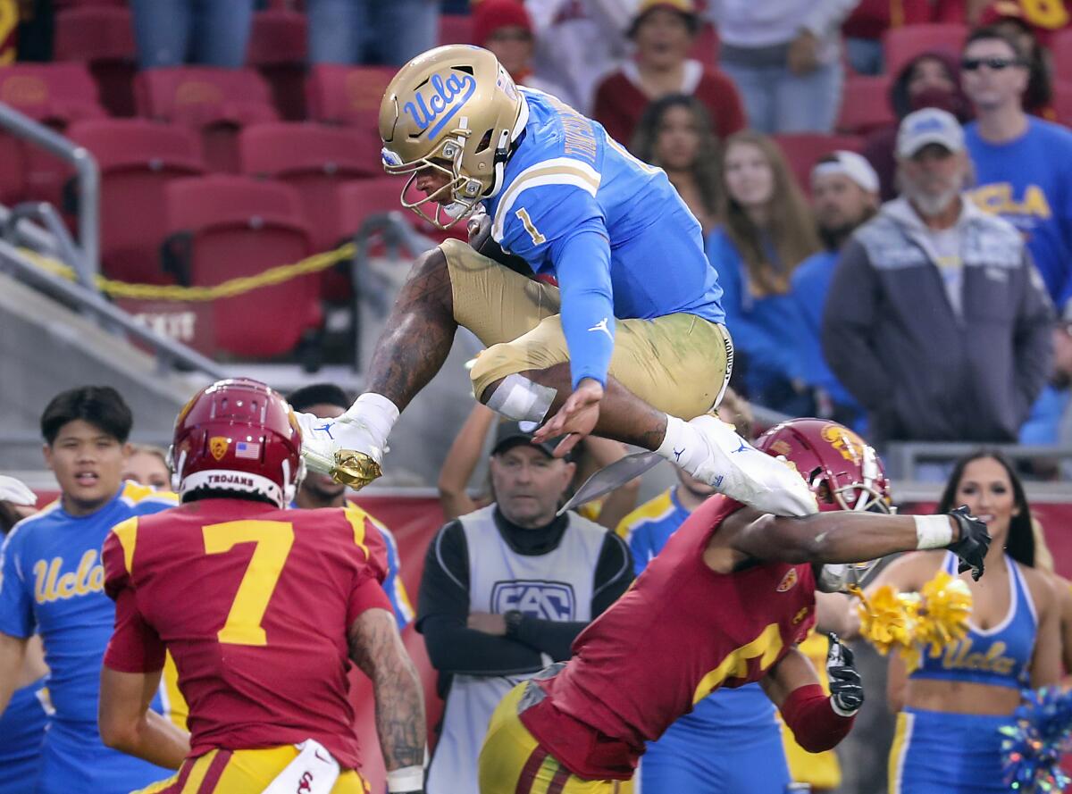 A football player jumps over other players.