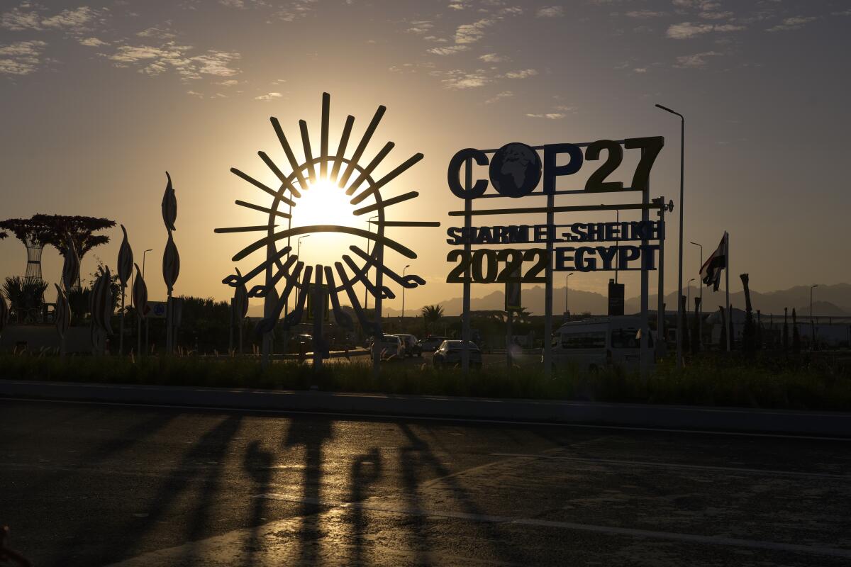 The sun sets behind the COP27 logo outside the venue of the COP27 U.N. Climate Summit, Saturday, Nov. 12, 2022, in Sharm el-Sheikh, Egypt. (AP Photo/Peter Dejong)