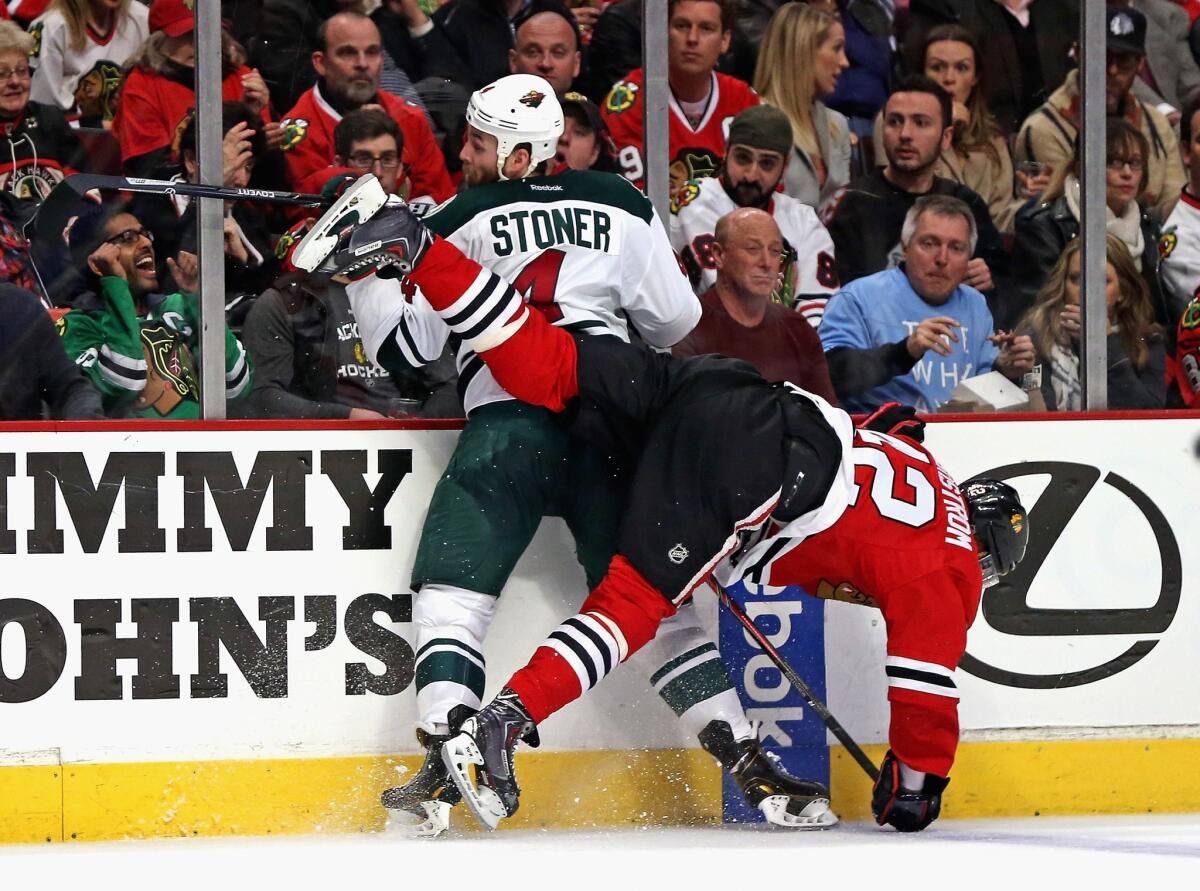 Minnesota's Clayton Stoner stays upright during a collision with Chicago's Joakim Nordstrom on May 2.