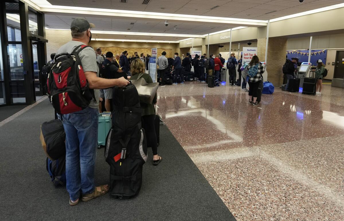 A line of travelers in an airport