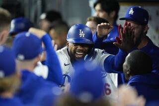 Los Angeles Dodgers' Teoscar Hernandez, center, is congratulated by teammates after hitting a home run.