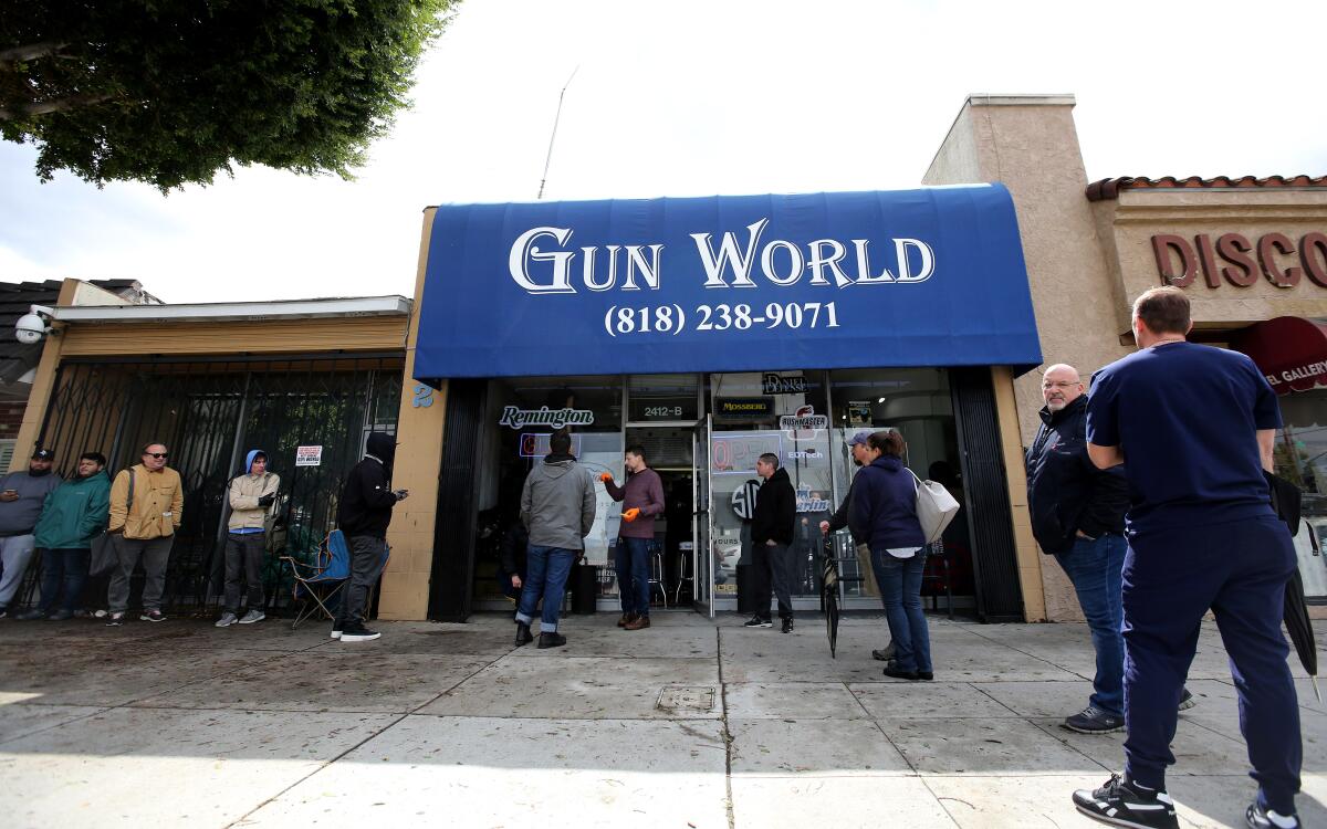 Customers line up outside Gun World on Magnolia Avenue in Burbank on March 17.
