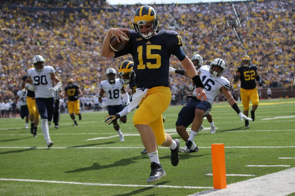 Michigan quarterback Jake Rudock scores on a 17-yard run against BYU in the first half.