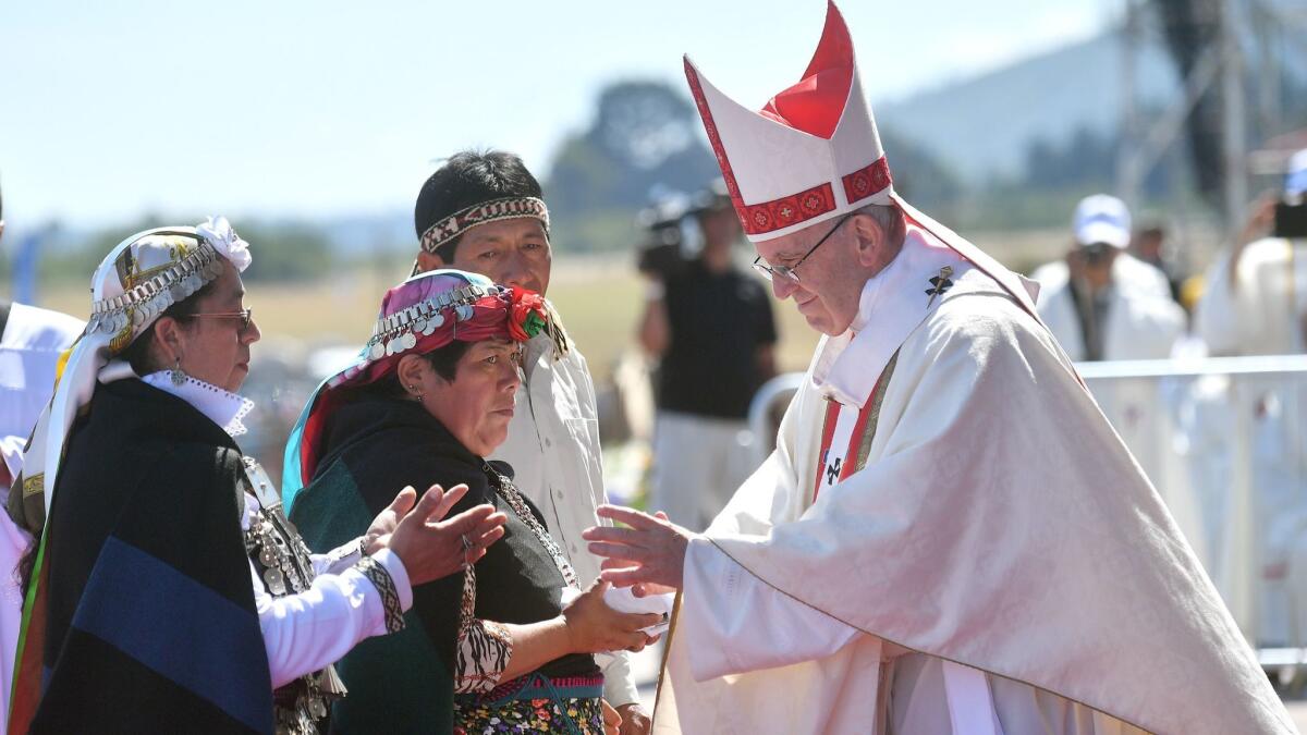 Pope Francis greets Mapuche people during Mass at an airport near Temuco, Chile, on Wednesday.