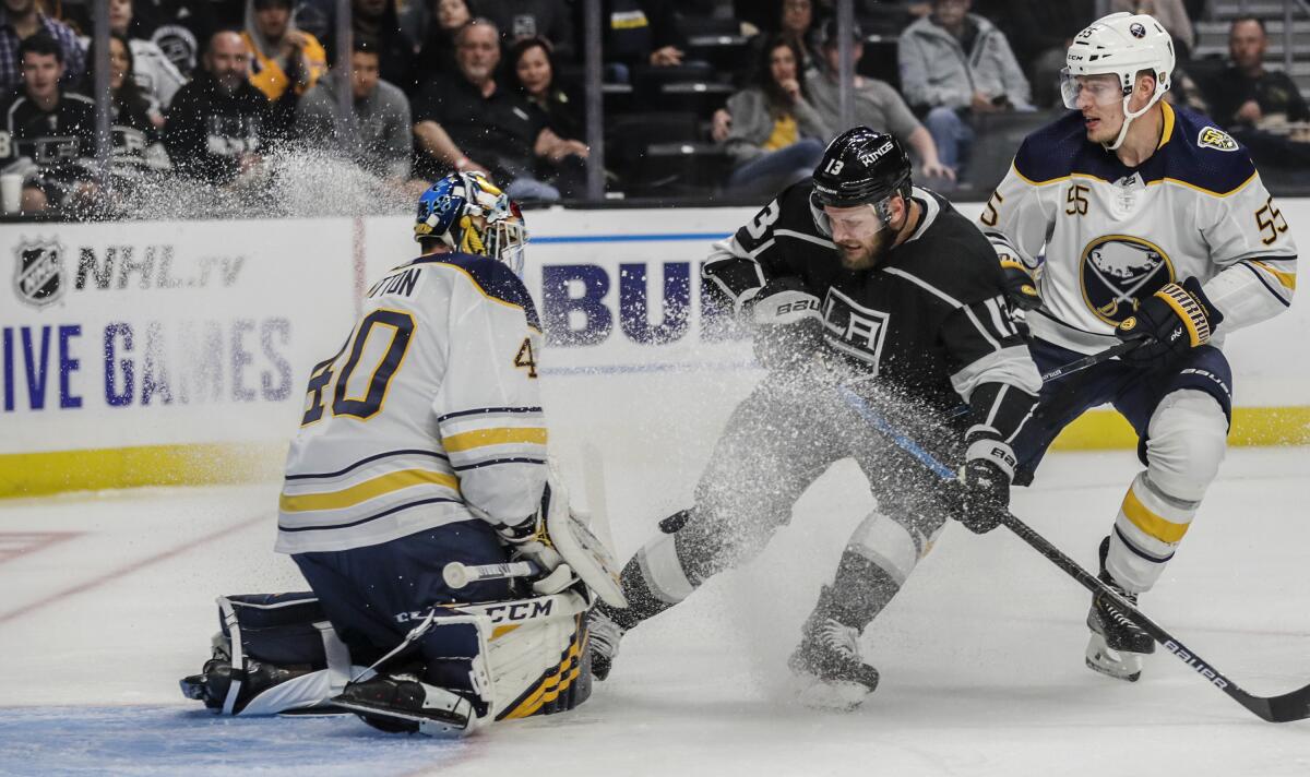 Buffalo Sabres goaltender Carter Hutton stops a shot by Kings left wing Kyle Clifford.