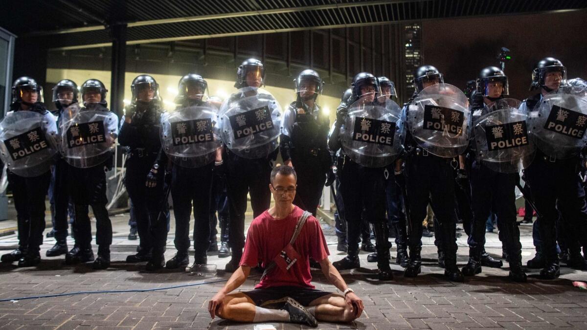 Police gather at a rally against a controversial extradition law proposal in Hong Kong on Sunday.