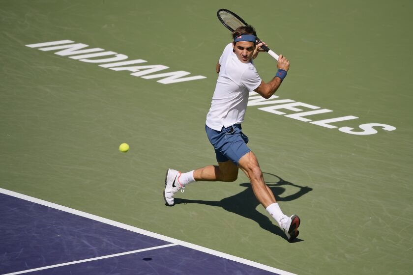 Roger Federer returns a shot to Hubert Hurkacz during the BNP Paribas Open tennis tournament in Indian Wells, Calif. 