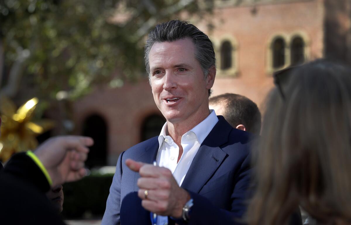 Lt. Gov. Gavin Newsom speaks with members of the public following a debate at USC in January.