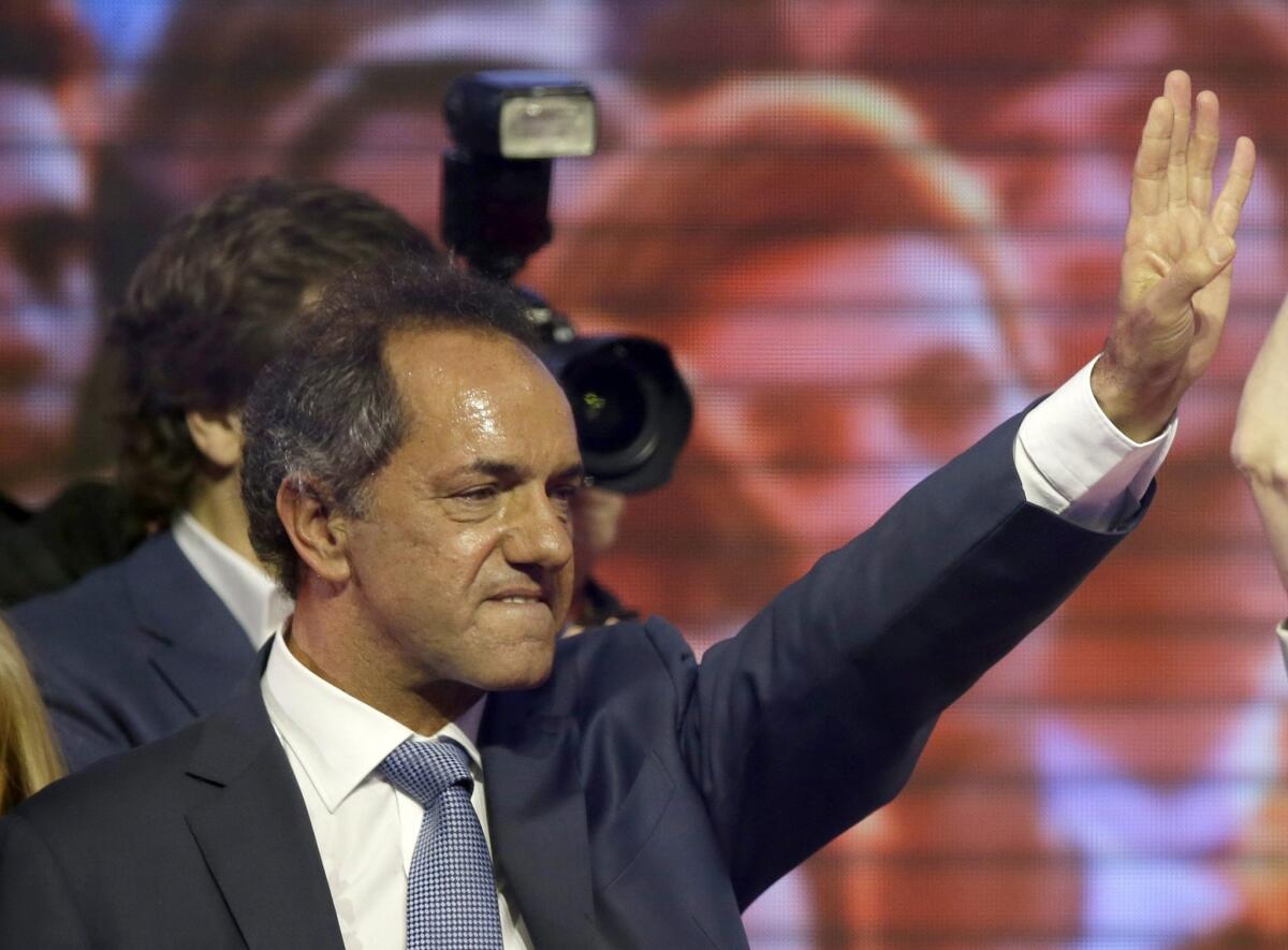 Daniel Scioli, the presidential candidate of Argentina's ruling party, stands on a stage as supporters cheer him on at Luna Park in Buenos Aires on Oct. 25.