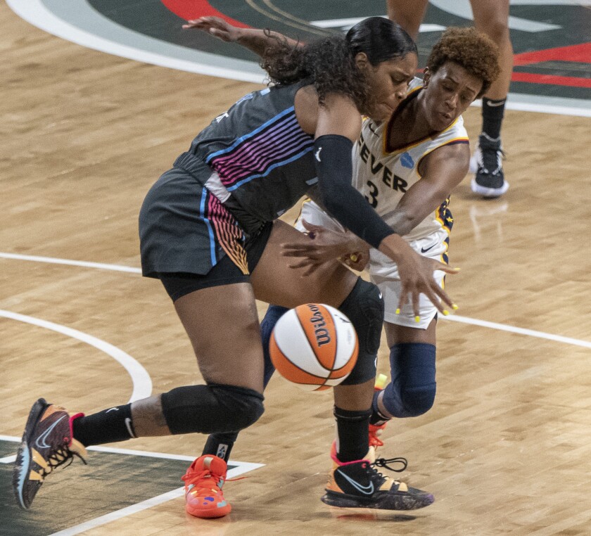 Indiana Fever guard Danielle Robinson (3) tries to steal ball from Atlanta Dream forward Cheyenne Parker (32) in 1st half of a WNBA game Sunday, July 11, 2021, in College Park, Ga. (AP Photo/Hakim Wright Sr.)
