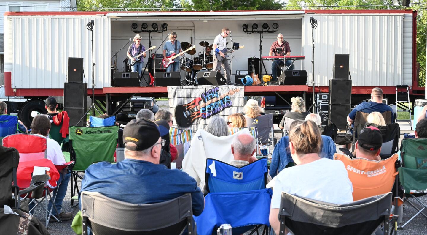 People listen as the band Half Serious performs on stage during the carnival at the Harney Volunteer Fire Company on Tuesday, June 25.