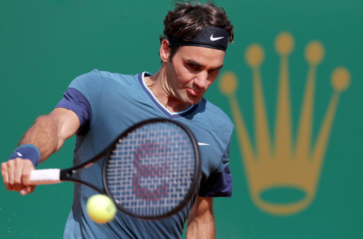 Roger Federer hits a backhand return against Novak Djokovic on Saturday in the semifinals of the Monte Carlo Masters tournament.