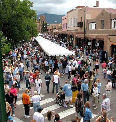 New Mexicos Santa Fe Plaza area is packed with booths and people during the event.