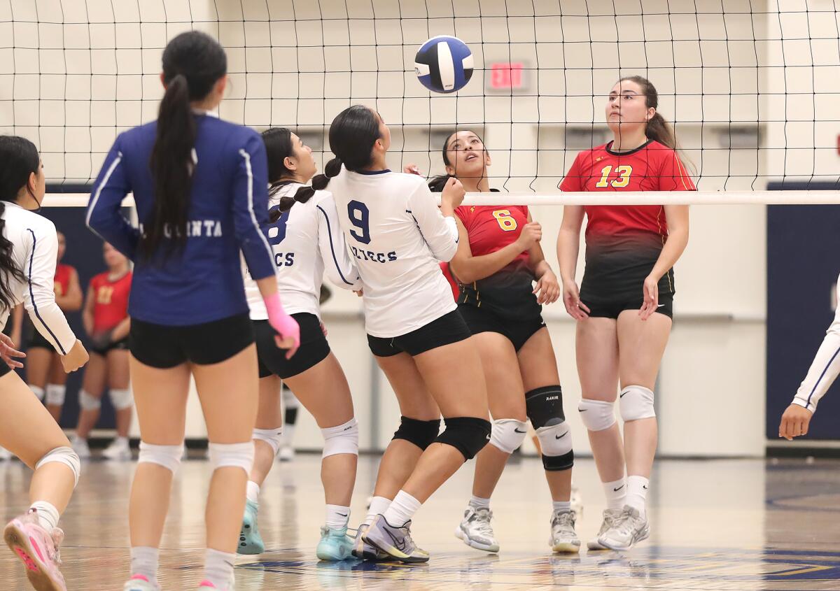 Estancia's Evelyn Maya (6) tips a ball over the net as La Quinta's Lesley Perez (9) keeps it in play on Tuesday.