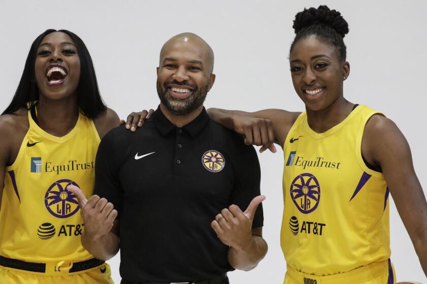 LOS ANGELES, CA - MAY 14, 2019  Spark playing sisters Chiney Ogwumike, left, and Nneka Ogwumike with head coach Derek Fisher, center, on media day held at L.A. Southwest College, Los Angeles. (Irfan Khan / Los Angeles Times)