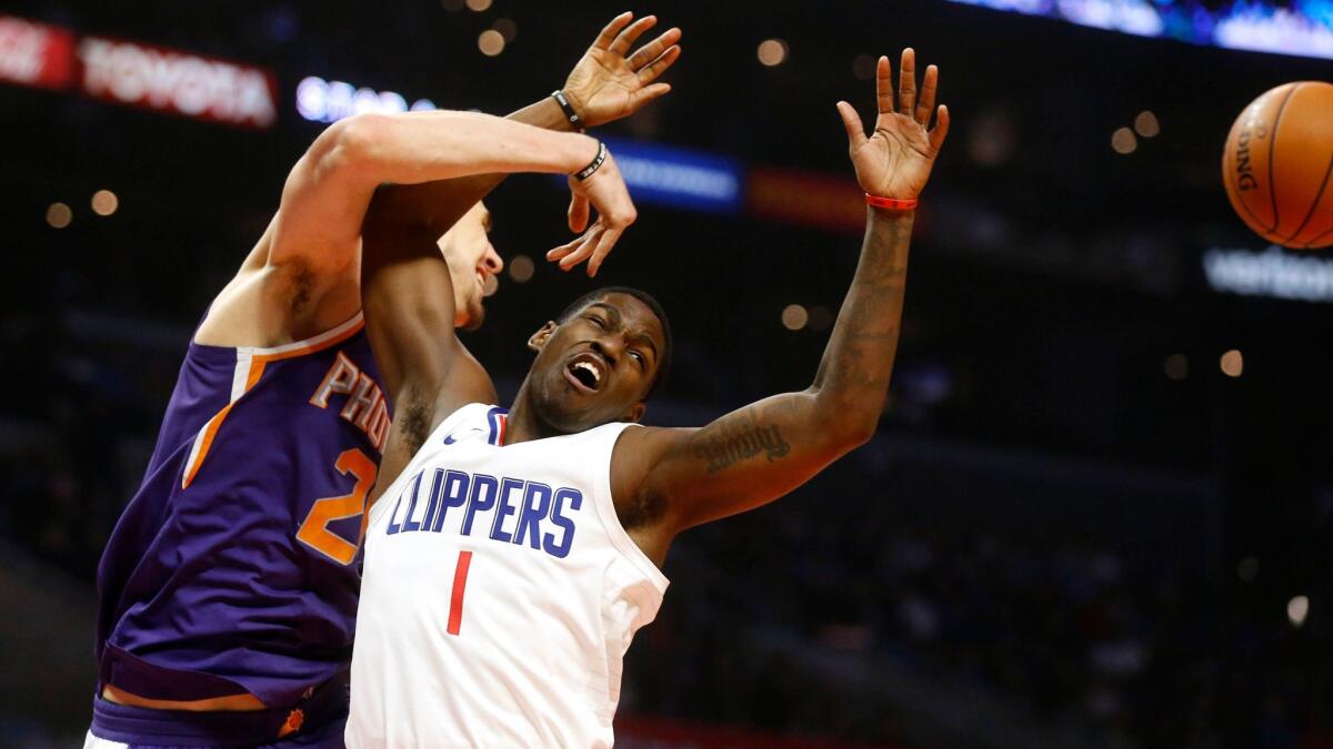 Clippers guard Jawun Evans, battling Phoenix Suns center Alex Len for a rebound Wednesday, is an outstanding defender.