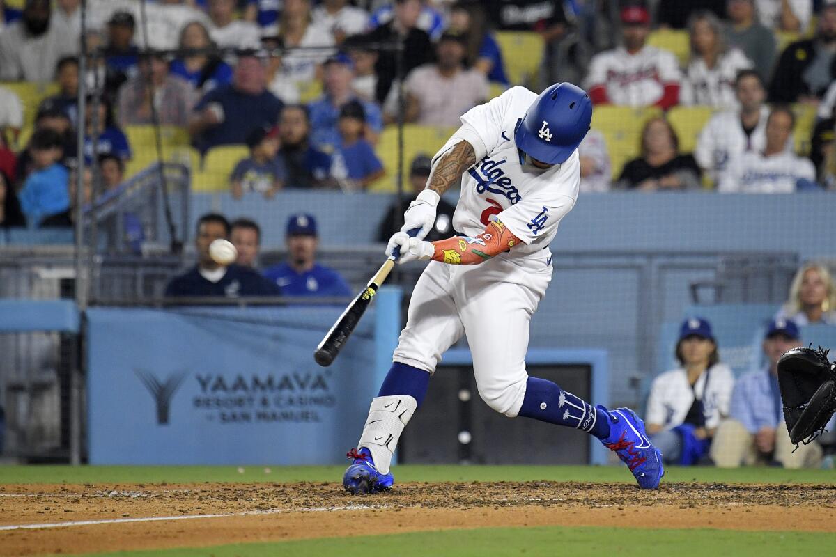 Kolten Wong hits a three-run home run during the eighth inning of the Dodgers' 6-3 loss Friday to the Atlanta Braves.