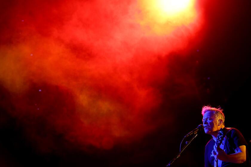 Guitarist/singer Bernard Sumner fronts New Order during a performance at the Greek Theatre in Los Angeles on July 13.