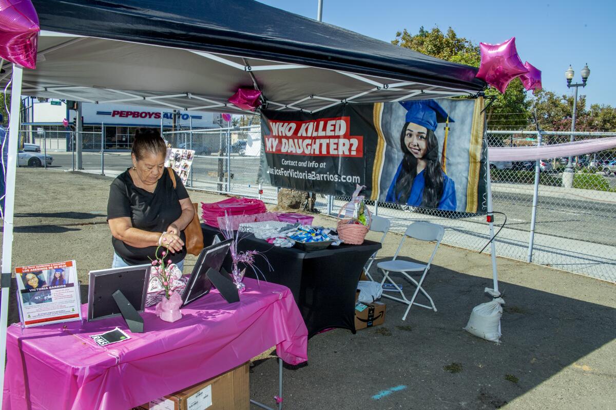 Bertha Espinoza looks at portraits of Victoria Barrios at a mural unveiling on Saturday, Aug. 28.