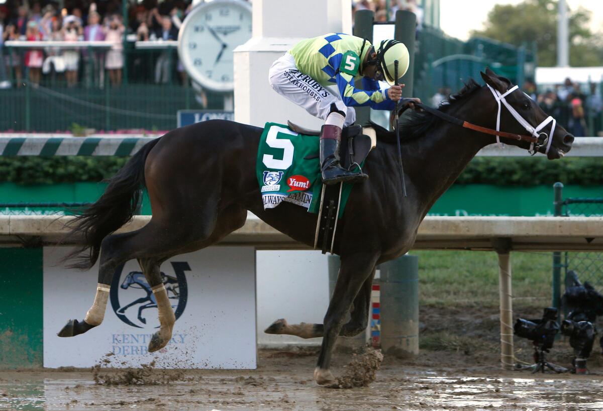 Jockey John Velazquez celebrates as he crosses the finish line aboard Always Dreaming to win the 143rd Kentucky Derby.