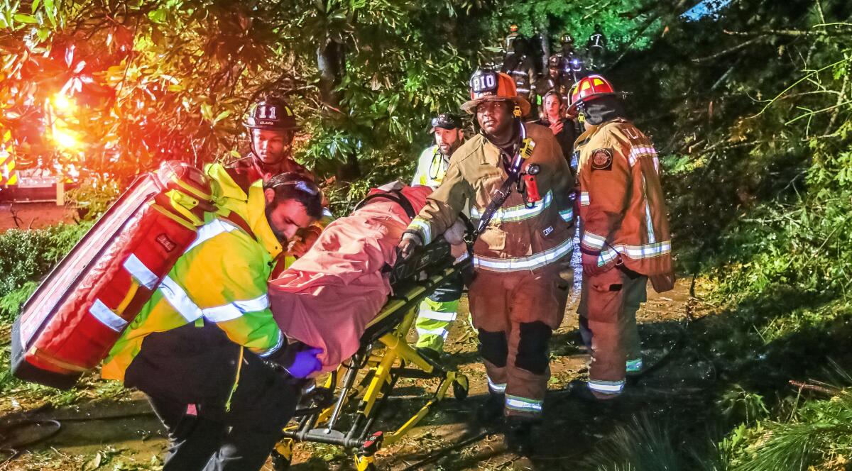 Atlanta firefighters transport a man in a gurney.