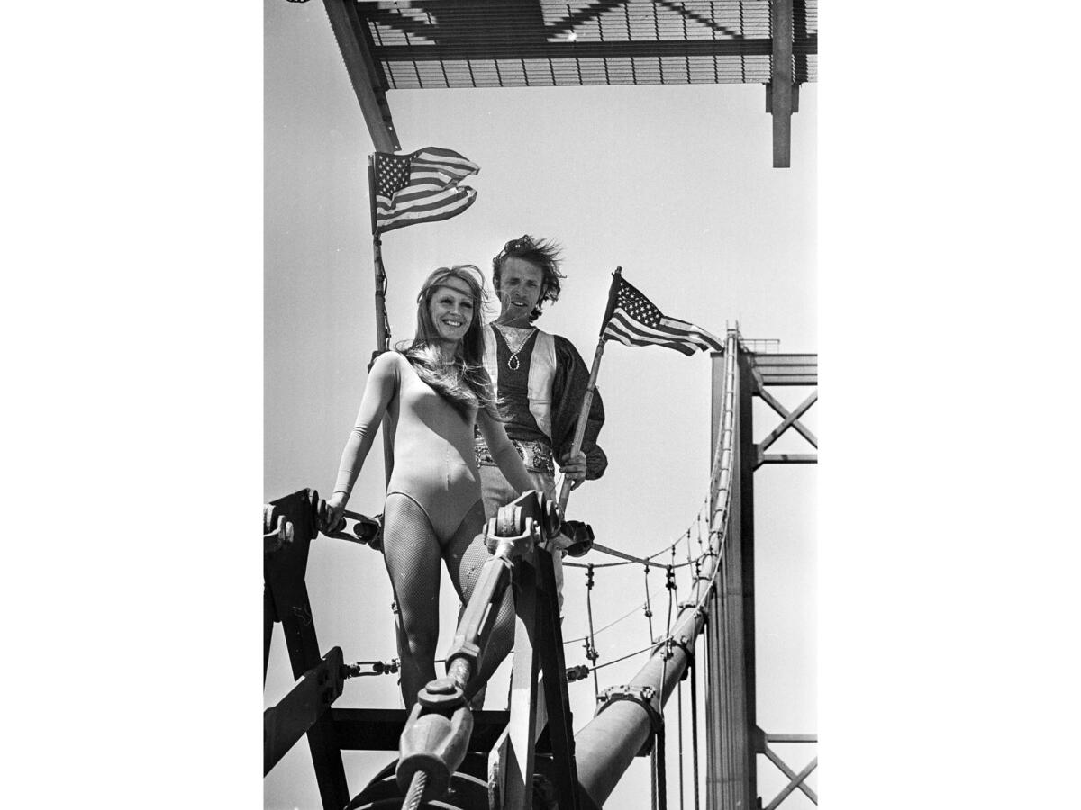 April 2, 1976: Tightrope-walker Steve McPeak, right, and assistant Celeste Farr, just after he crossed the top of the Vincent Thomas Bridge in San Pedro..