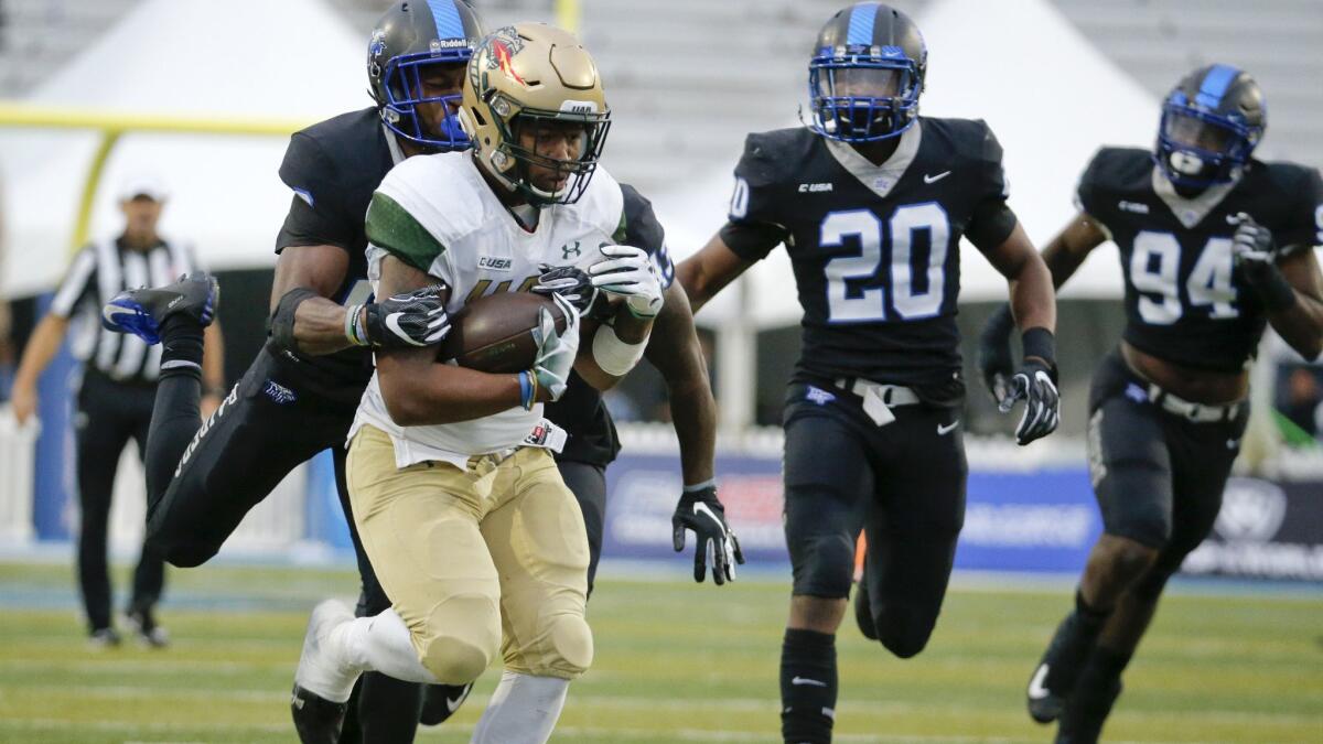 UAB running back Spencer Brown, front left, carries the ball against Middle Tennessee during the second half of the Conference USA championship on Saturday.